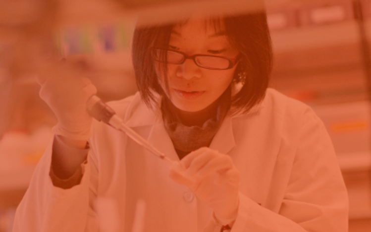 Scientist with a pipette in a biomedical laboratory